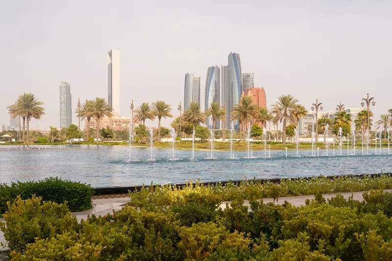 Abu Dhabi skyline with fountains and palm trees